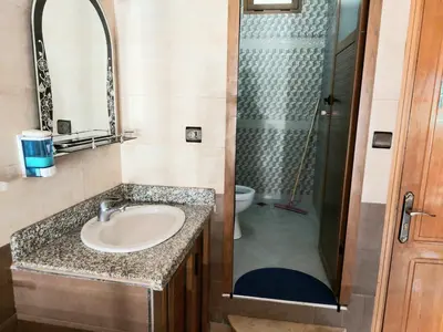 a bathroom with a sink and a shower at Gite Rahhaoui Simo in Kasba des Aït Moussa