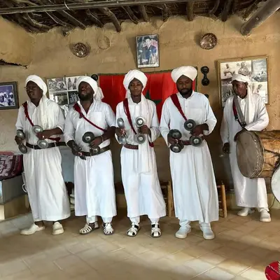 a group of men standing in a room holding balls at Sahara Magic luxury Camp in Merzouga