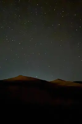 a starry night in the desert with a field at Sahara Magic luxury Camp in Merzouga