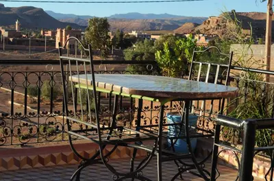 a table and chairs on a balcony with a view at CHEZ MANAR in Ouarzazate