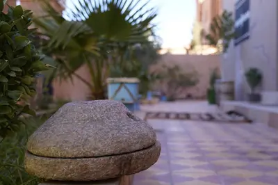 a rock sitting on the side of a courtyard at CHEZ MANAR in Ouarzazate