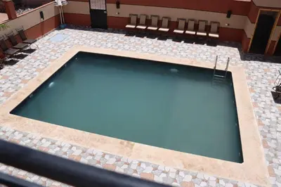 an empty swimming pool with a tiled floor at CHEZ MANAR in Ouarzazate