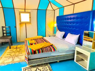 a bedroom with a bed in a tent at Desert night Camp in Merzouga