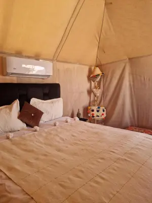 a bedroom with a large bed in a tent at marvelous luxury desert stars in Merzouga