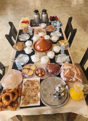 a table with many different types of food on it at marvelous luxury desert stars in Merzouga