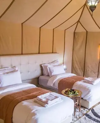 a room with two beds in a tent at marvelous luxury desert stars in Merzouga
