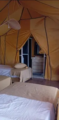 a tent with two beds in a room at marvelous luxury desert stars in Merzouga