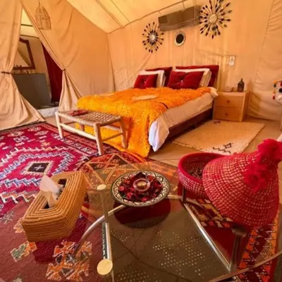 a bedroom with a bed in a tent at marvelous luxury desert stars in Merzouga