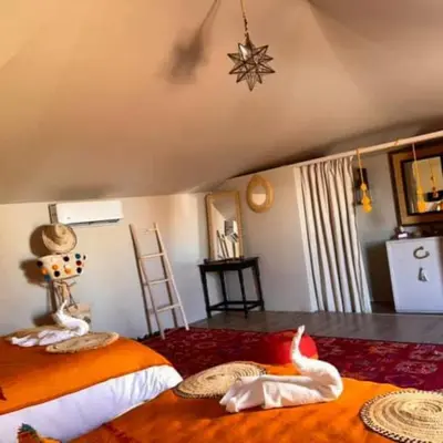 a bedroom with two beds and a star on the ceiling at marvelous luxury desert stars in Merzouga