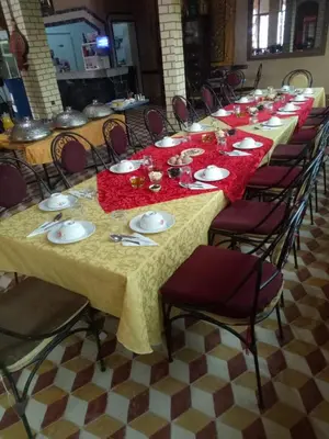 a long table with plates and napkins on it at El Menzeh Foundation in Rissani