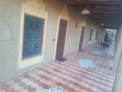 an empty hallway of a house with a tile floor at El Menzeh Foundation in Rissani
