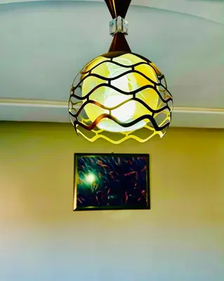 a yellow and white pendant light hanging from a ceiling at COMPLEXE L'OASIS in Erfoud