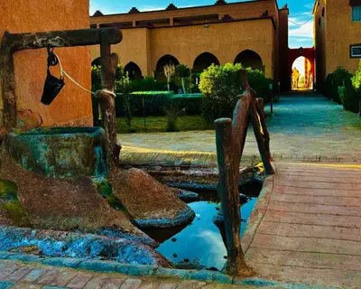 a water fountain in front of a building at COMPLEXE L'OASIS in Erfoud
