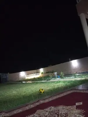 a yellow soccer ball on the grass at night at Villa 30 km a Marrakech in Marrakech
