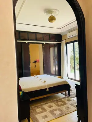 a bedroom with a bed and a large mirror at Villa MsHolidays Victoria privatisée Marrakech in Marrakech