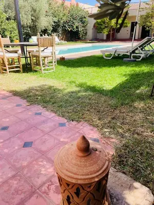a fire hydrant sitting on a patio next to a pool at Villa MsHolidays Victoria privatisée Marrakech in Marrakech