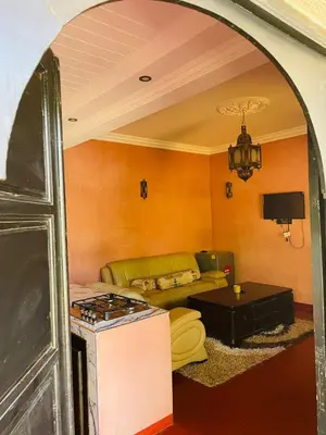 a living room with a couch and a stove at Villa MsHolidays Victoria privatisée Marrakech in Marrakech