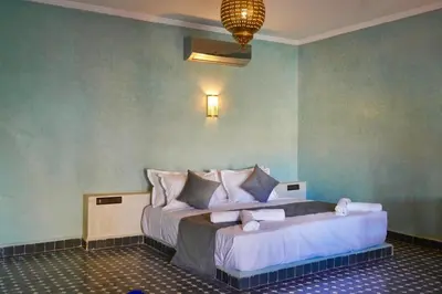 a bedroom with a large bed in a room at Hotel Sunset Palace in Merzouga
