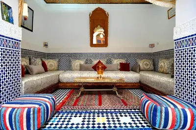 a living room with two couches and a table at Riad Tafoukt Palace in Fès