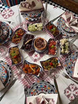 a table with plates of food on a table at Riad Tafoukt Palace in Fès