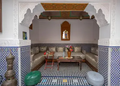 a living room with a couch and a table at Riad Tafoukt Palace in Fès