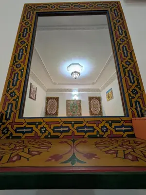 a large mirror on the wall of a room at Riad Tafoukt Palace in Fès