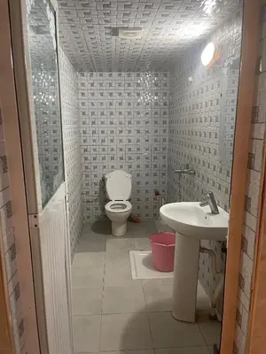 a bathroom with a toilet and a sink at اقامة قرب حمام my yaacup in Moulay Yacoub
