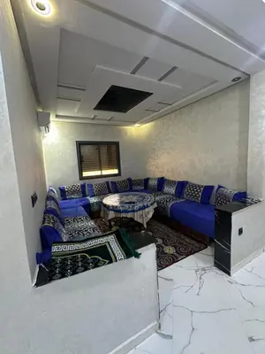 a living room with a couch and a table at اقامة قرب حمام my yaacup in Moulay Yacoub