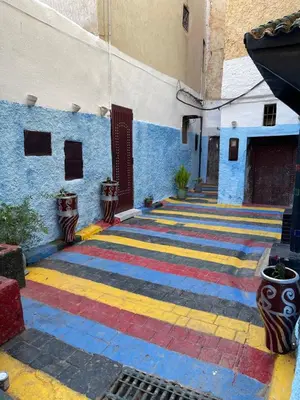 a hallway with a colorful rug on the side of a building at Dar Achraf in Fès