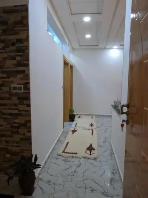 a hallway with a prayer rug on the floor at Tislite d azrou in Azrou