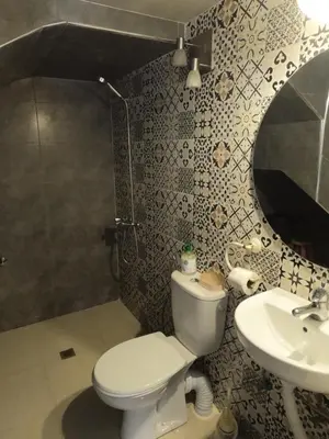 a bathroom with a toilet and a sink at Tislite d azrou in Azrou