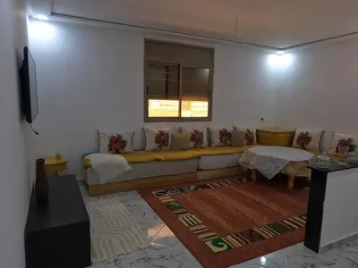 a living room with a couch and a window at Tislite d azrou in Azrou
