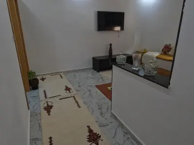 a living room with a rug on the floor at Tislite d azrou in Azrou