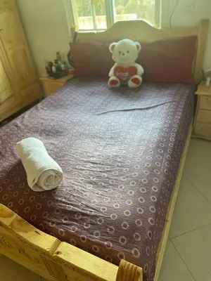 a teddy bear sitting on top of a bed at تازة in Taza