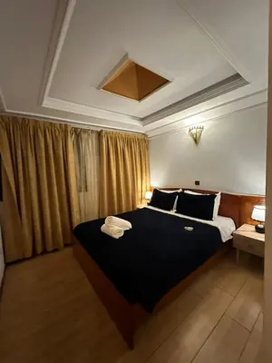 a bedroom with a large bed with towels on it at Amrouss touristic DarMaroc in Azrou