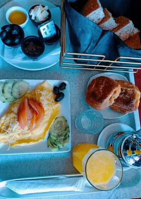 two plates of food on a table with breakfast foods at Amrouss touristic DarMaroc in Azrou