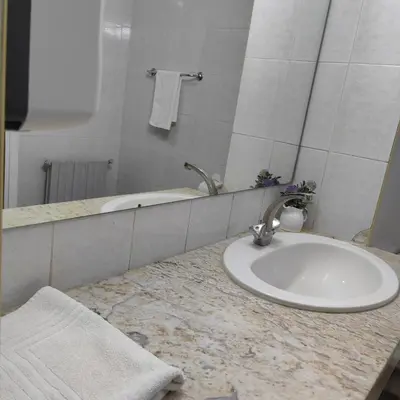 a bathroom counter with a sink and a mirror at Amrouss touristic DarMaroc in Azrou