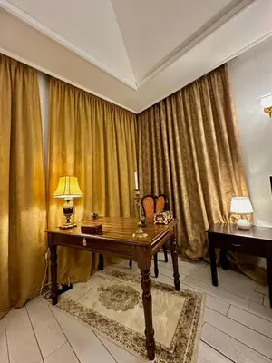 a room with a desk with a lamp on it at Amrouss touristic DarMaroc in Azrou