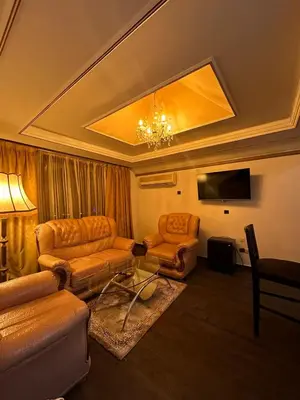 a living room with two couches and a tv at Amrouss touristic DarMaroc in Azrou