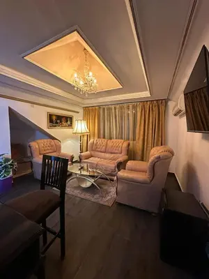 a living room with a couch and a table at Amrouss touristic DarMaroc in Azrou