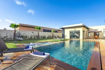 a swimming pool in the backyard of a house at Villa Lella, piscine Chauffée, cuisinière in Marrakech