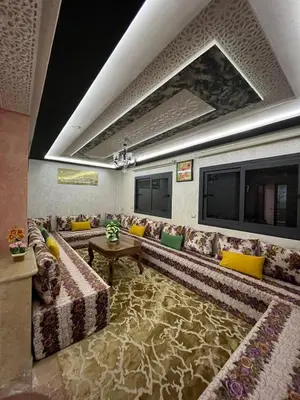 a large living room with couches and a tv at APPART HOTEL OUED EDDAHAB in Khenifra