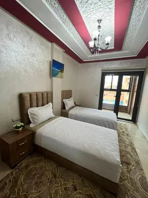 a bedroom with two beds and a window at APPART HOTEL OUED EDDAHAB in Khenifra