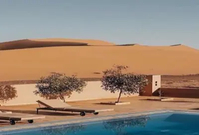 a swimming pool in the middle of a desert at Merzouga bivouac star in Taouz