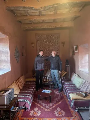 two people are standing in a living room at Kasbah Tigmi El Janoub in Aït Ben Haddou