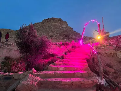 a staircase covered in pink lights in the desert at Kasbah Tigmi El Janoub in Aït Ben Haddou