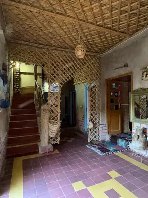 a room with a staircase in a house with a ceiling at GITE LA GROTTE VALLEE in Aoûtouss