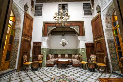 a living room with a couch and a chandelier at Dar Usham Fes Luxury Guest House in Fès