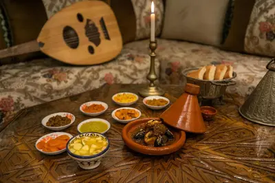 a table topped with different types of food and a candle at Dar Usham Fes Luxury Guest House in Fès