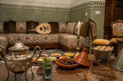 a living room with a table with food on it at Dar Usham Fes Luxury Guest House in Fès